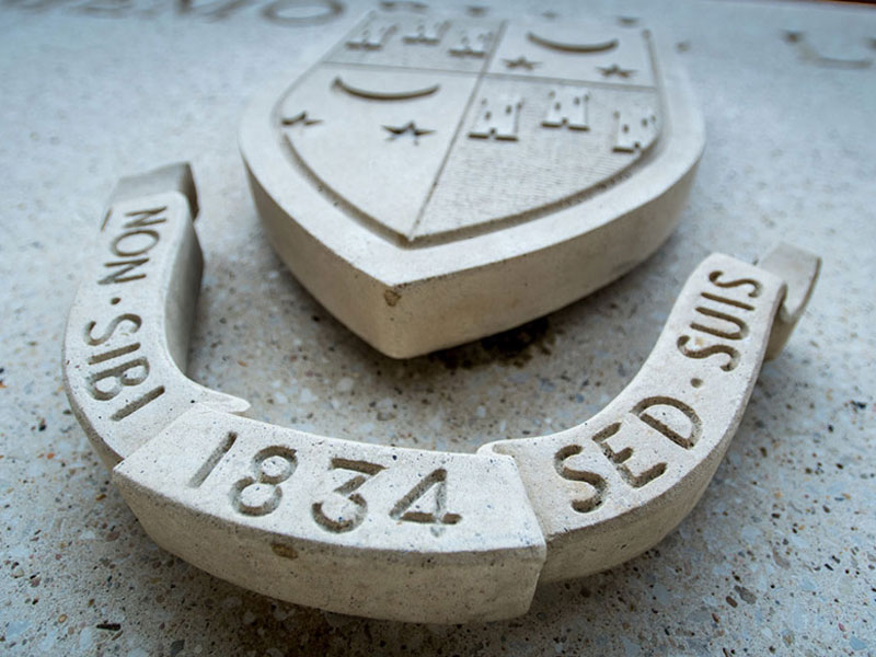 Closeup of concrete relief depicting Tulane Shield
