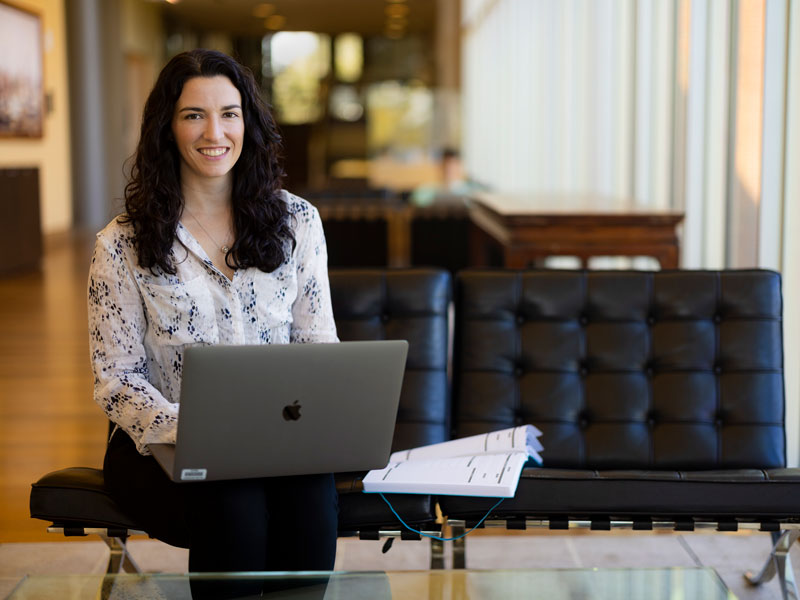 Smiling woman working on laptop