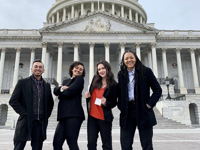 Four students standing in front of the Capital Building in Washington D C