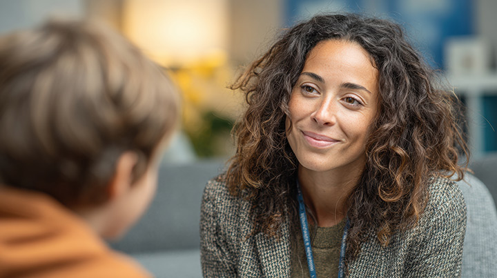 Woman providing counseling services to a child.