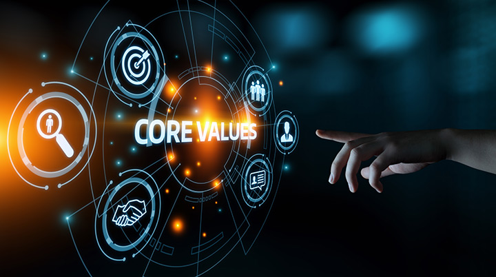 Illustration of a hand pointing toward a glowing "Core Values" with graphics around the type.