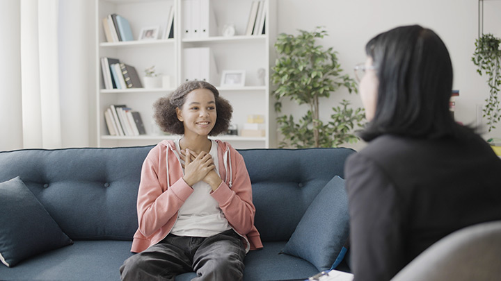 Young girl in a private counseling session with a social worker.