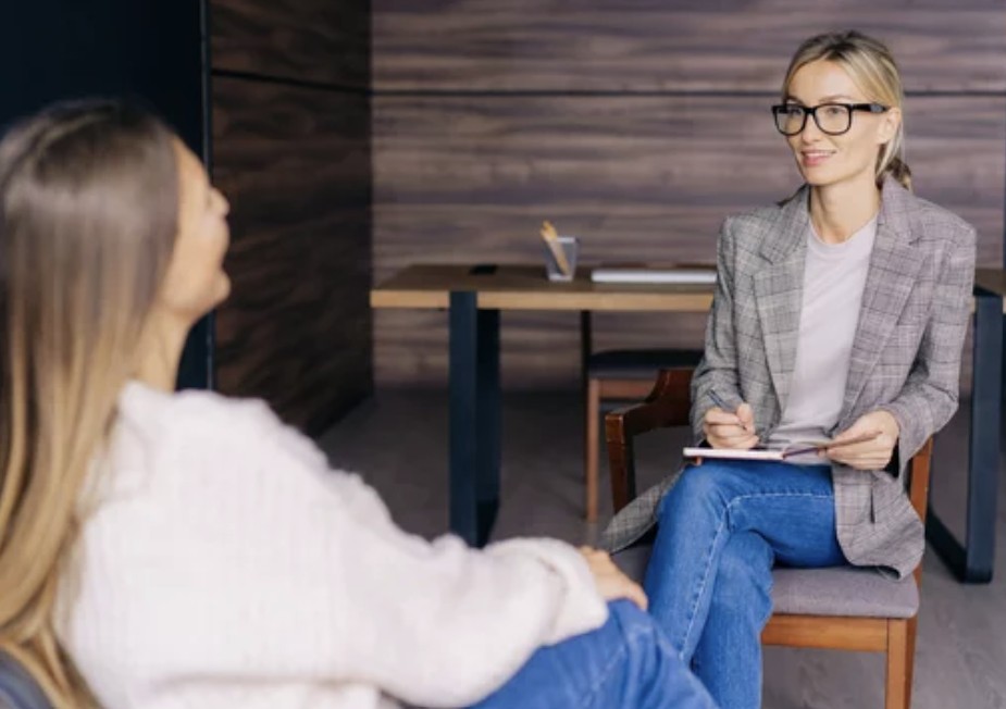 A social worker consults with a client in her office.