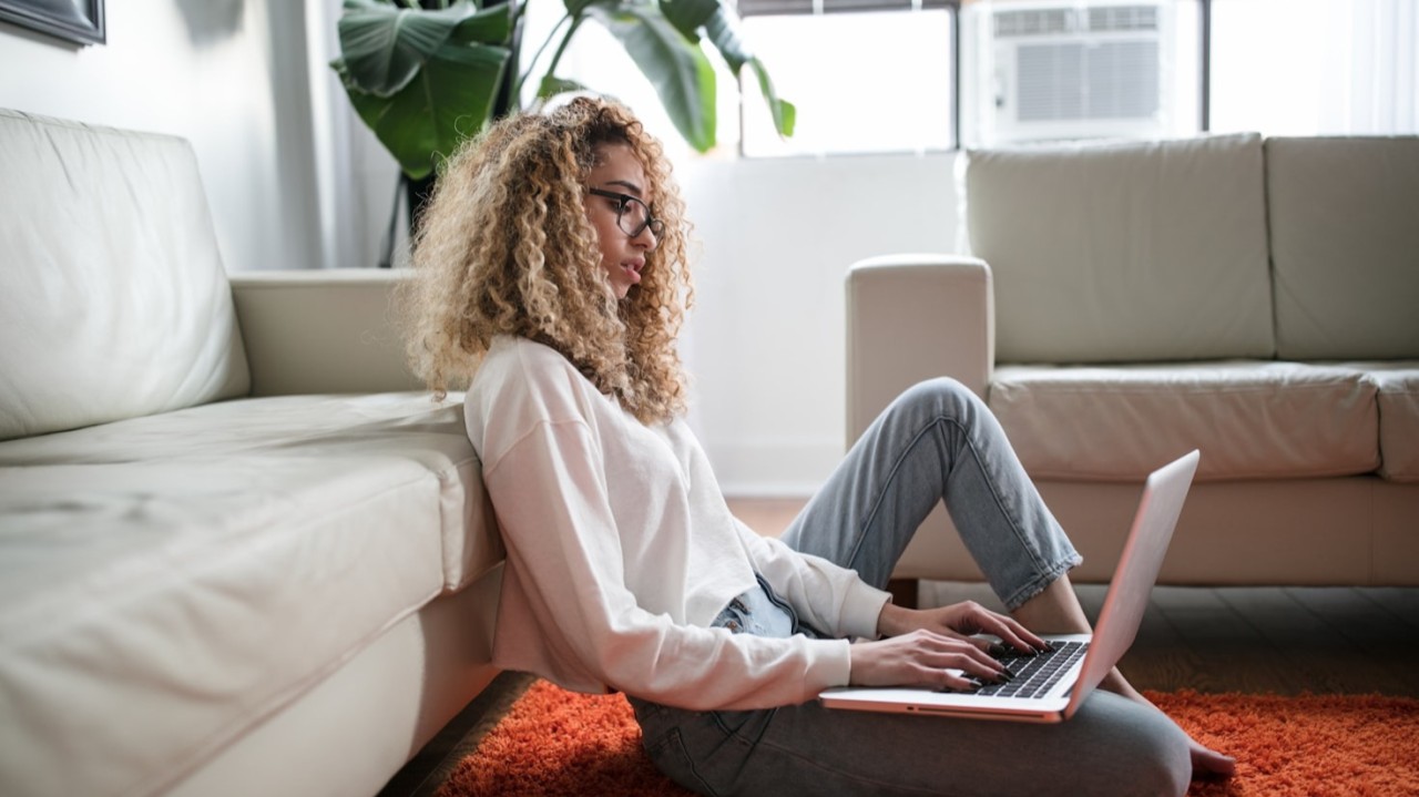 woman sitting on the floor using a computer